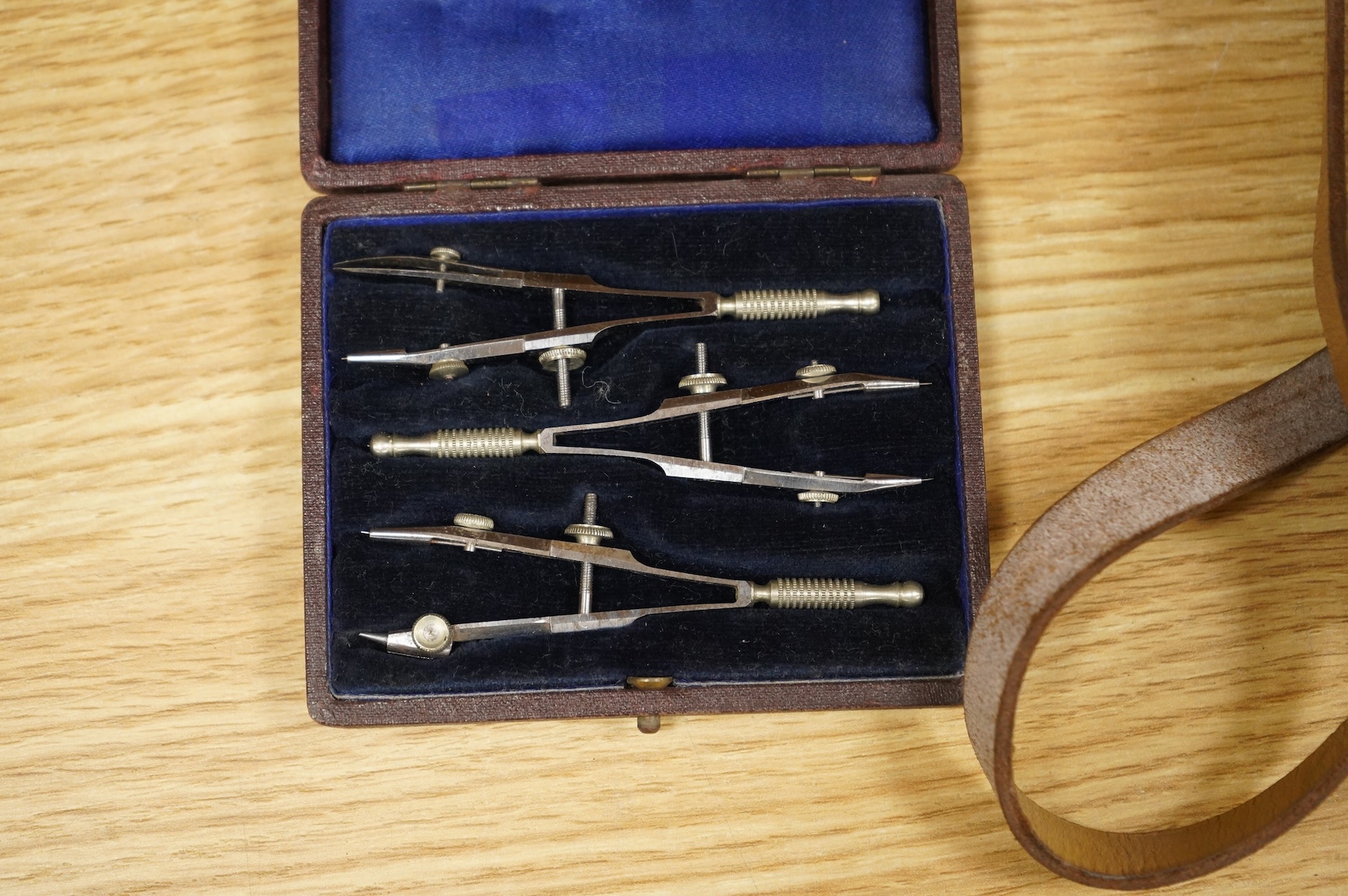 Four scientific instruments, consisting; a set of apothecaries steel balance scales, by Charles de Grave, 59, St. Martin’s le Grand…London; a set of three small drawing compasses, leather cased; a prismatic compass, by S